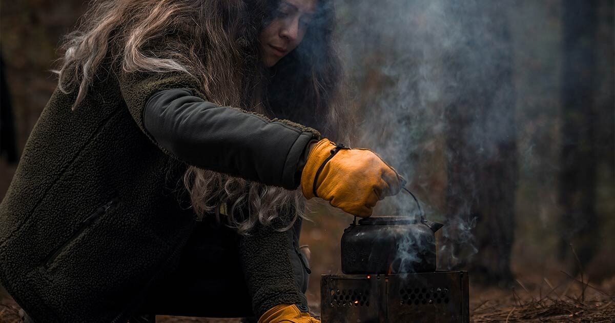 Boiling Water over a fire practicing skills