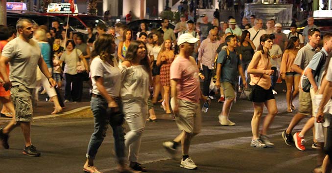 A bunch of people walking on a street unaware of what's going on around them