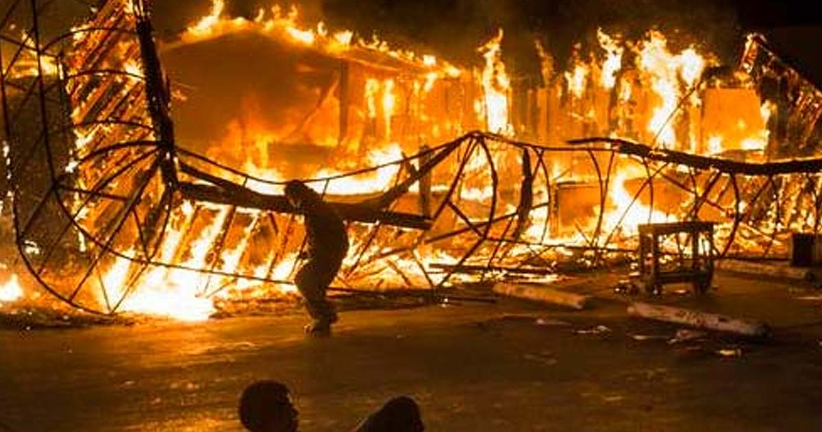 People Looting and burning down a building