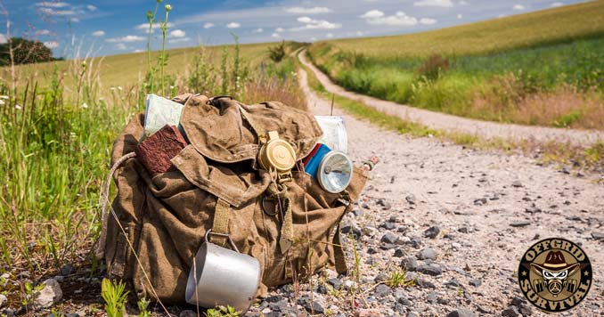 gear bag with a trail map sitting on a hiking trail